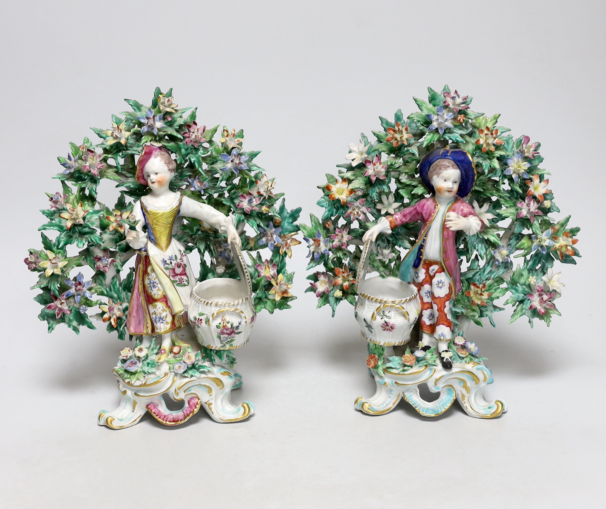 A pair of 18th century Bow figural sweetmeats, c.1765, each with marks to the base, 23cm high